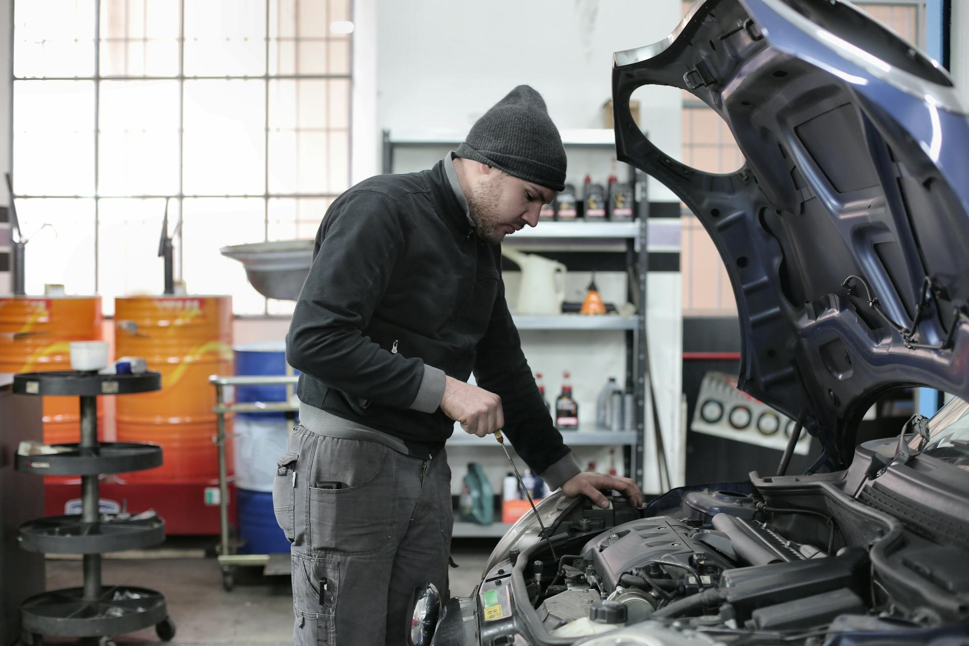 Mechanic checking a car engine during maintenance